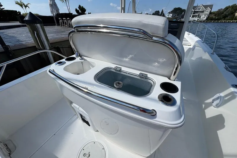 Slide: The Image of 2015 Boston Whaler 270 Dauntless boat with open storage compartment and cup holders. - 13