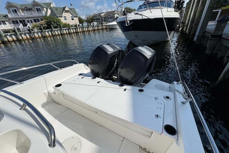 Slide: The Image of 2015 Boston Whaler 270 Dauntless with dual engines docked near waterfront homes. - 14