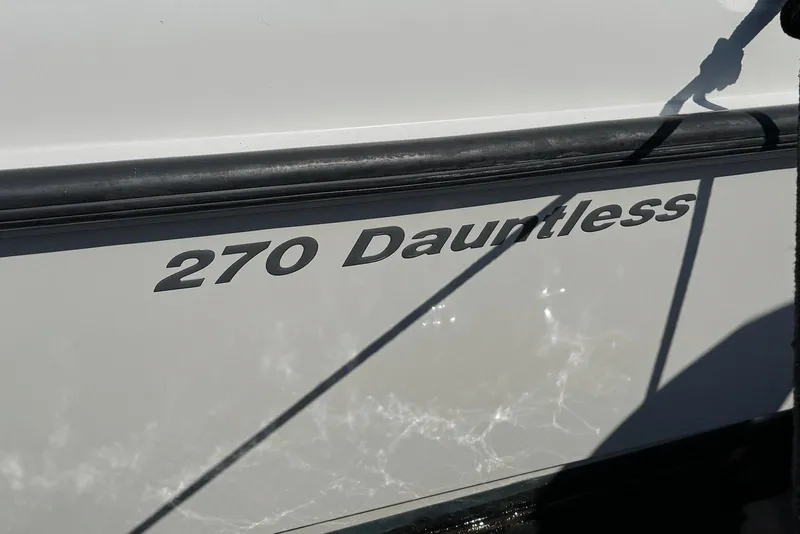 Slide: The Image of Close-up of 2015 Boston Whaler 270 Dauntless boat name on hull. - 16