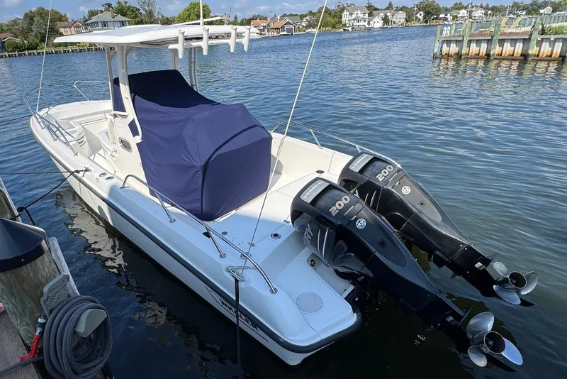 Slide: The Image of 2015 Boston Whaler 270 Dauntless boat docked with twin 200 HP engines. - 17