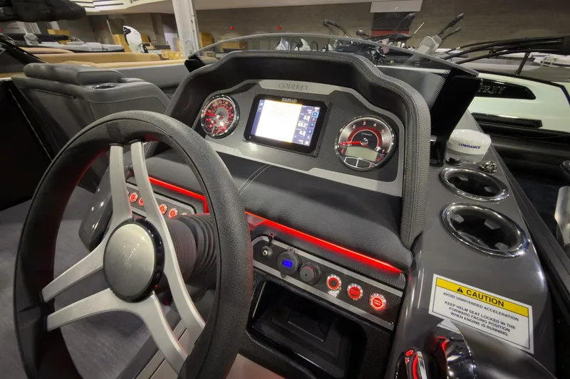 Slide: The Image of Dashboard of 2026 Godfrey Monaco 255 Ultra Lounge boat with modern controls and steering wheel. - 15