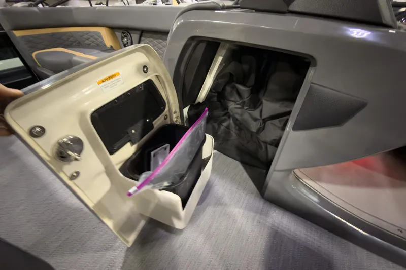 Slide: The Image of 2026 Godfrey Monaco 255 Ultra Lounge storage compartment with open door and interior view. - 19