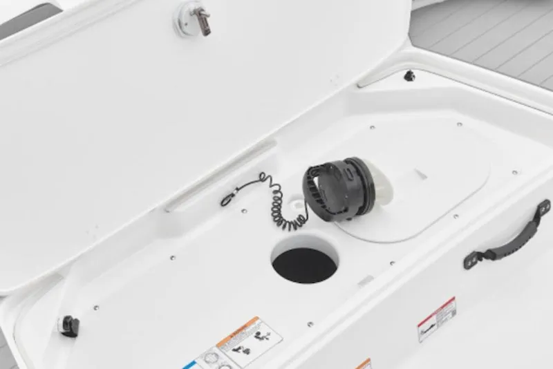 Slide: The Image of Open storage compartment in 2026 Yamaha Boats AR190, featuring a secure latch and coiled cable. - 5