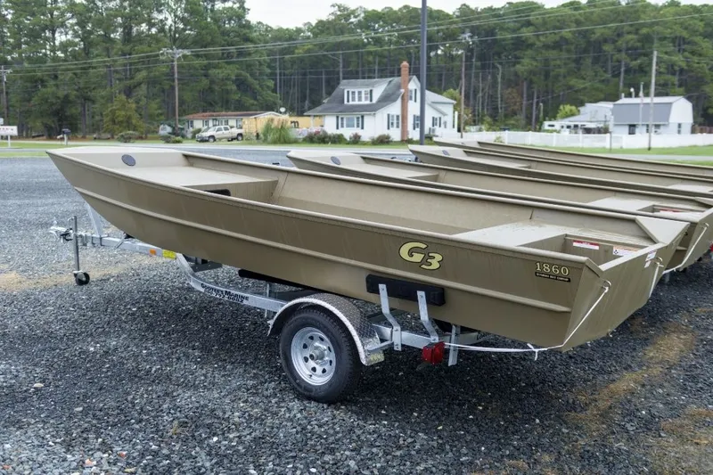 The Image of 2026 G3 Gator Tough 1860 VBW boat on trailer at dealership lot. - 1