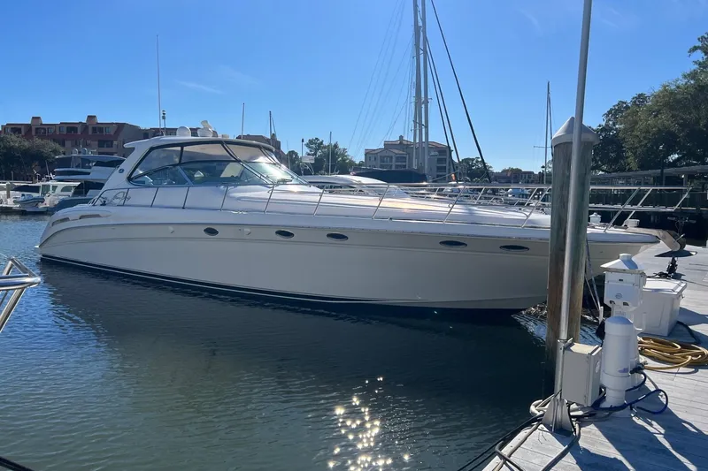 The Image of 1998 Sea Ray 540 Sundancer yacht docked in a marina under clear blue skies. - 0