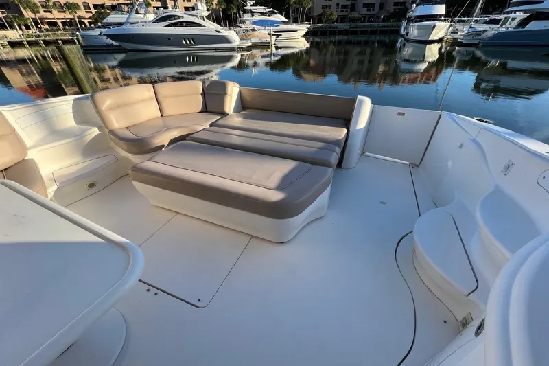 Slide: The Image of Spacious deck seating on 1998 Sea Ray 540 Sundancer yacht, docked in a serene marina. - 16