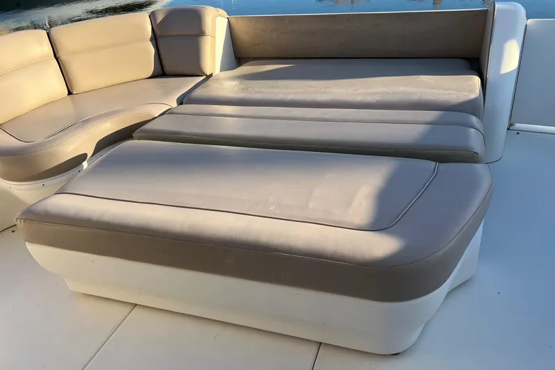 Slide: The Image of Luxurious seating on a 1998 Sea Ray 540 Sundancer yacht, featuring beige cushions. - 17