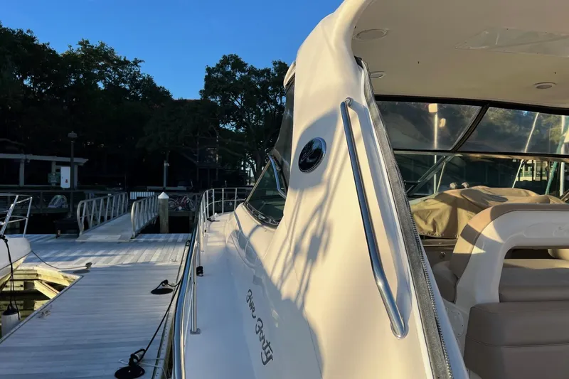 Slide: The Image of 1998 Sea Ray 540 Sundancer yacht docked at marina, side view in sunlight. - 2