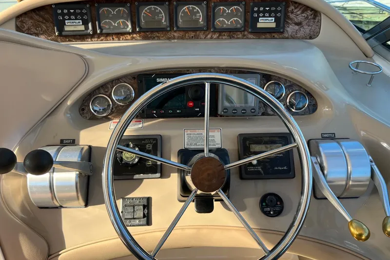 Slide: The Image of 1998 Sea Ray 540 Sundancer helm with steering wheel, gauges, and controls. - 20