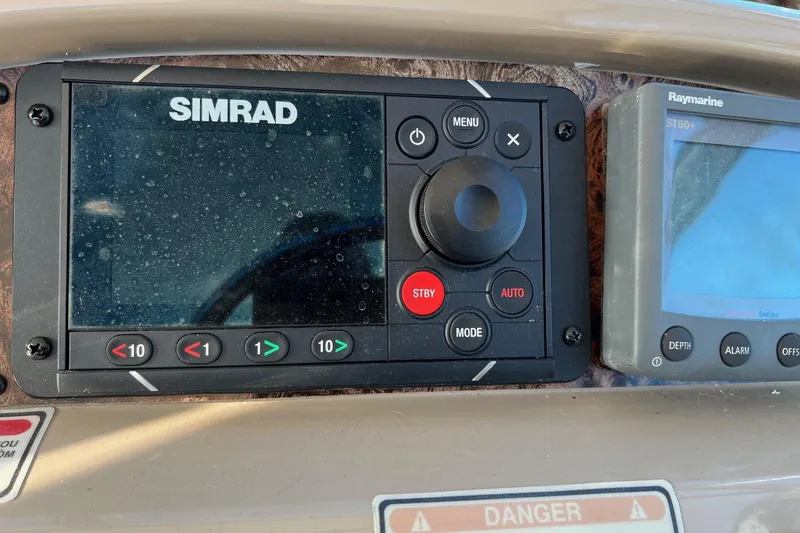 Slide: The Image of Control panel of a 1998 Sea Ray 540 Sundancer with Simrad and Raymarine displays. - 24