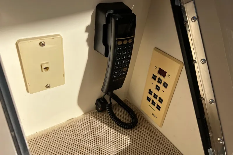 Slide: The Image of 1998 Sea Ray 540 Sundancer interior with vintage phone and control panel. - 27