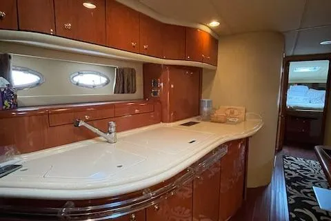 Slide: The Image of Luxurious 1998 Sea Ray 540 Sundancer yacht interior with elegant kitchen and wood cabinetry. - 36
