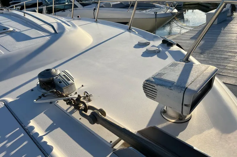Slide: The Image of 1998 Sea Ray 540 Sundancer deck with anchor and winch in marina. - 4