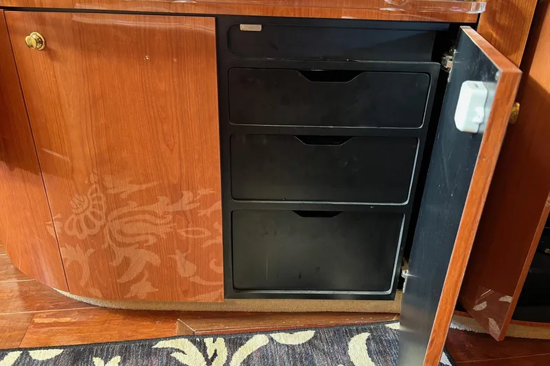 Slide: The Image of Wooden cabinet with open door revealing black drawers, Sea Ray 540 Sundancer 1998 interior. - 40