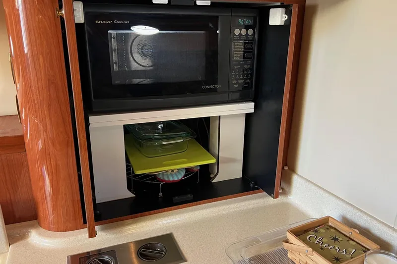 Slide: The Image of Microwave and storage in 1998 Sea Ray 540 Sundancer yacht kitchen. - 45
