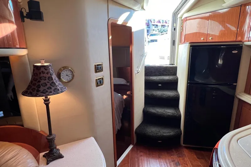 Slide: The Image of Interior of 1998 Sea Ray 540 Sundancer yacht with stairs, lamp, and refrigerator. - 46