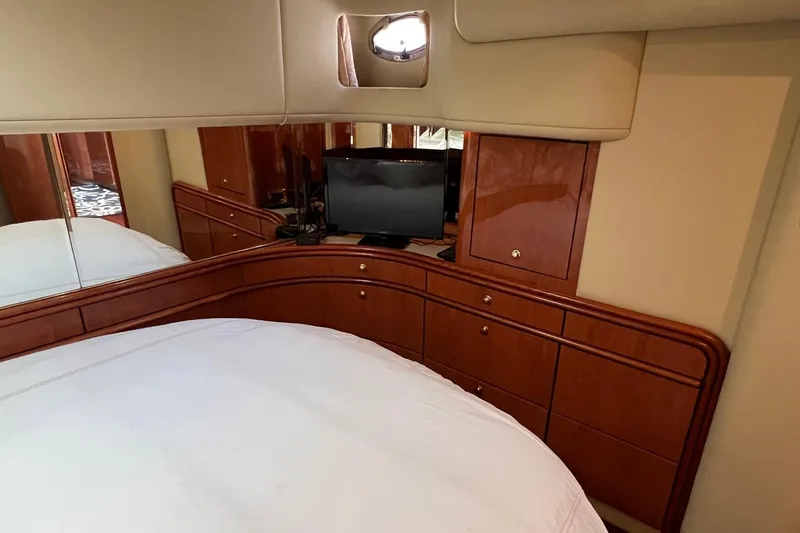 Slide: The Image of Luxurious cabin interior of 1998 Sea Ray 540 Sundancer yacht with TV and wooden cabinetry. - 49