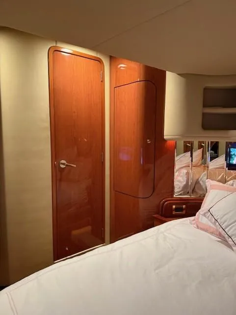 Slide: The Image of Interior cabin of 1998 Sea Ray 540 Sundancer yacht with wooden door and bed. - 51