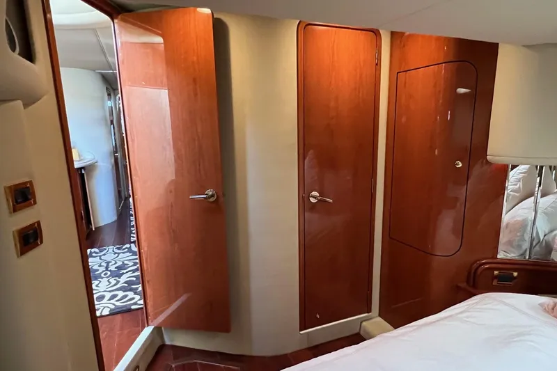 Slide: The Image of Interior of 1998 Sea Ray 540 Sundancer with wooden doors and cozy bedroom. - 52
