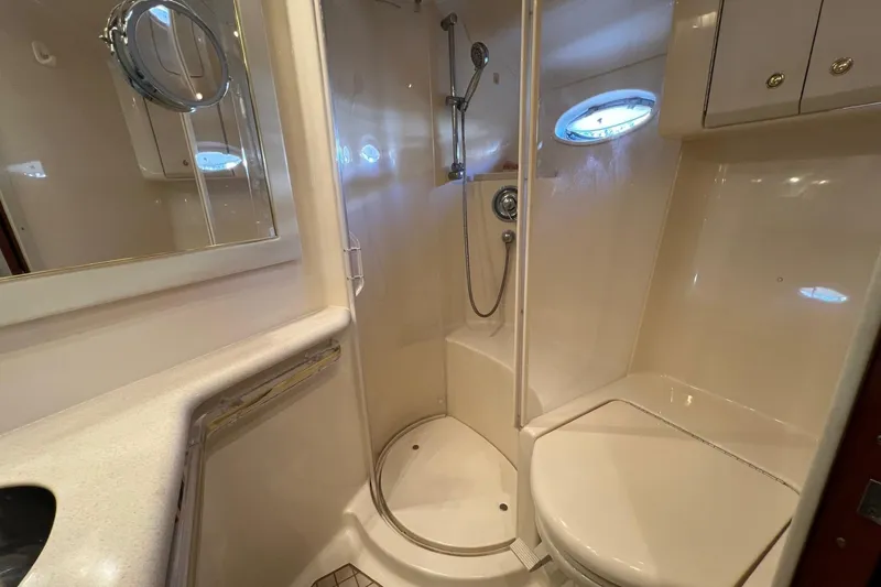 Slide: The Image of Bathroom interior of 1998 Sea Ray 540 Sundancer yacht, featuring shower and porthole window. - 54