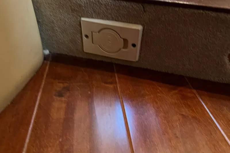 Slide: The Image of Power outlet on wooden floor of 1998 Sea Ray 540 Sundancer yacht interior. - 55