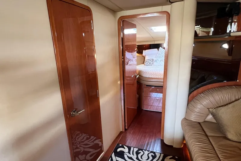 Slide: The Image of Luxurious 1998 Sea Ray 540 Sundancer interior with wood finishes and cozy bedroom. - 60