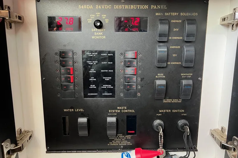 Slide: The Image of Control panel of a 1998 Sea Ray 540 Sundancer boat, showing battery and system switches. - 67