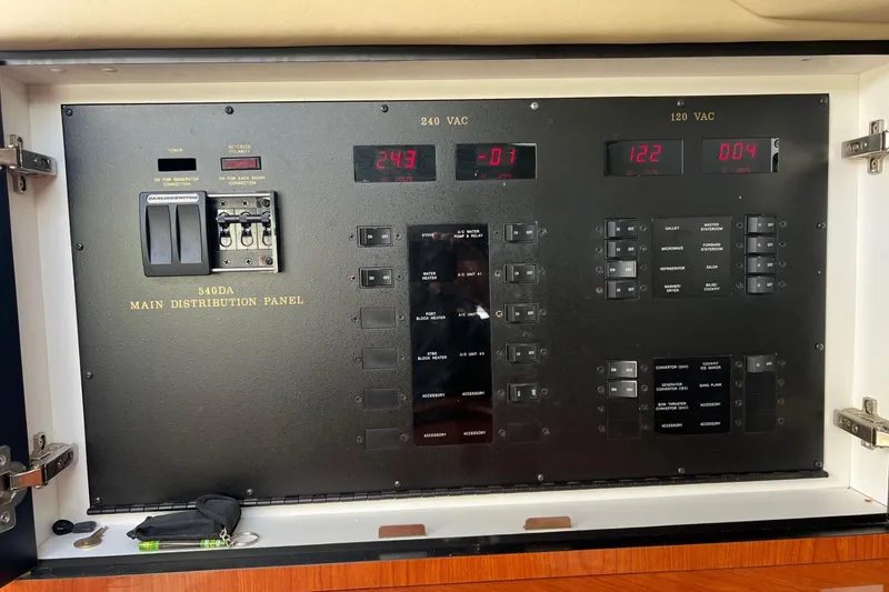 Slide: The Image of Main distribution panel of 1998 Sea Ray 540 Sundancer yacht, showing electrical controls and switches. - 68