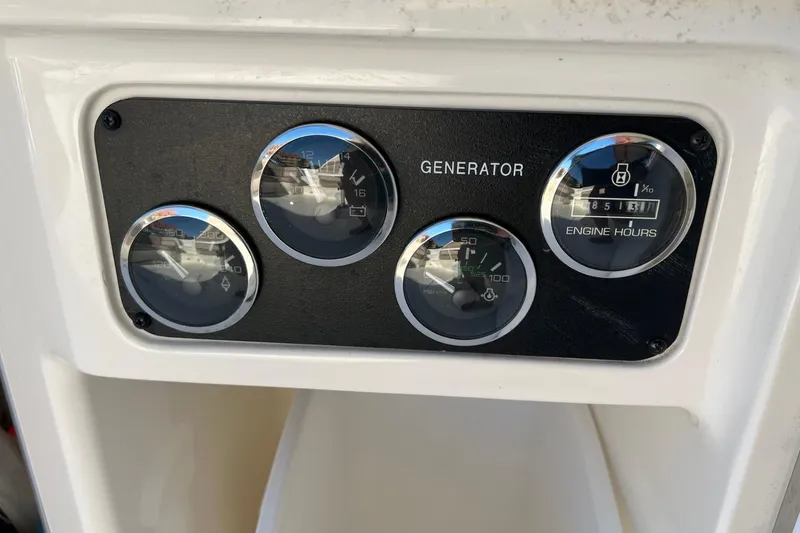 Slide: The Image of Control panel of a 1998 Sea Ray 540 Sundancer boat generator. - 69