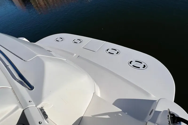 Slide: The Image of 1998 Sea Ray 540 Sundancer yacht deck, featuring sleek white design and water backdrop. - 7