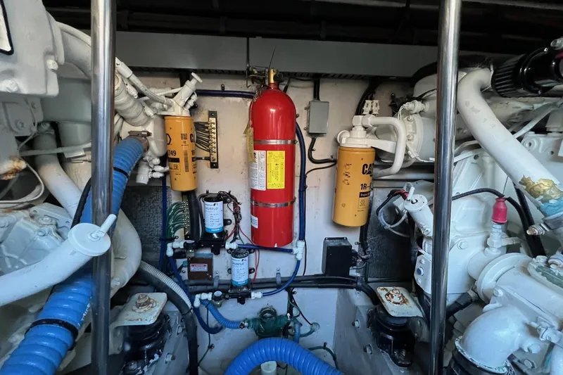 Slide: The Image of Engine room of 1998 Sea Ray 540 Sundancer with filters and fire extinguisher. - 72