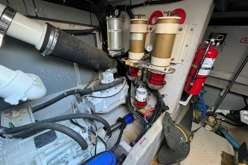 Slide: The Image of Engine room of 1998 Sea Ray 540 Sundancer with filters and fire extinguisher. - 77