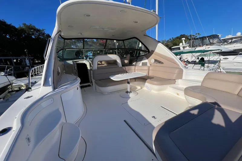 Slide: The Image of Spacious 1998 Sea Ray 540 Sundancer yacht interior with seating and table. - 8