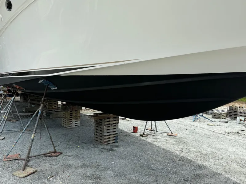 Slide: The Image of 1998 Sea Ray 540 Sundancer yacht hull on stands, undergoing maintenance. - 85