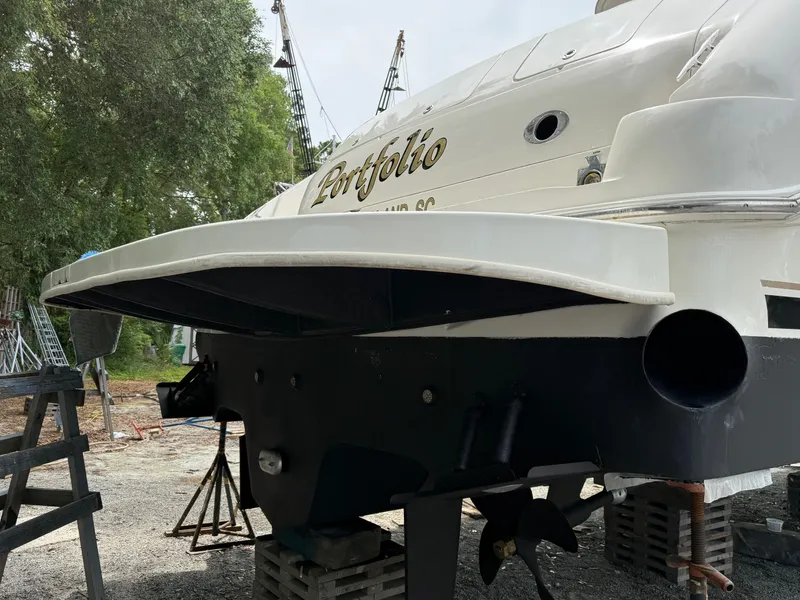 Slide: The Image of 1998 Sea Ray 540 Sundancer yacht on dry dock, rear view with propeller and rudder visible. - 88