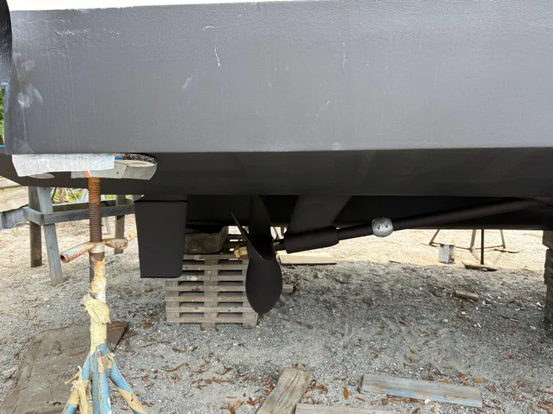 Slide: The Image of 1998 Sea Ray 540 Sundancer boat hull and propeller on dry dock. - 90