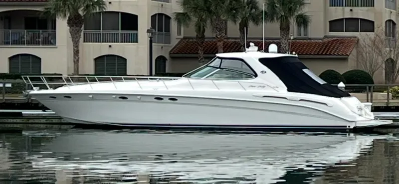 Slide: The Image of 1998 Sea Ray 540 Sundancer yacht docked near waterfront buildings. - 91