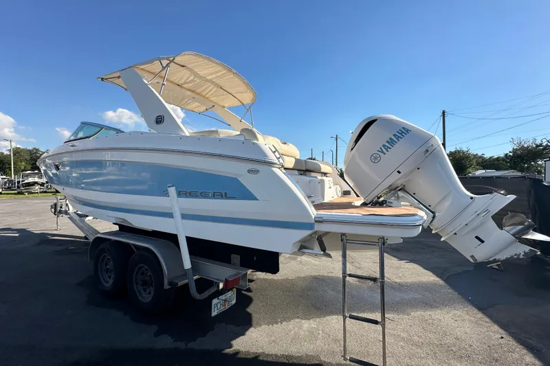 Slide: The Image of 2019 Regal 26 OBX boat with Yamaha outboard motor on trailer, sunny day. - 10