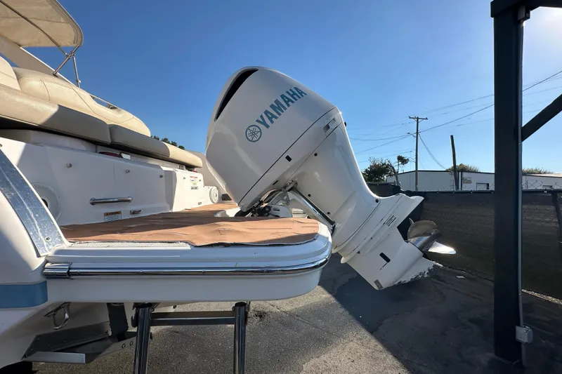 Slide: The Image of 2019 Regal 26 OBX boat with Yamaha outboard motor, docked under clear blue sky. - 11