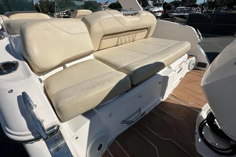 Slide: The Image of 2019 Regal 26 OBX boat with beige seating and wooden deck. - 14