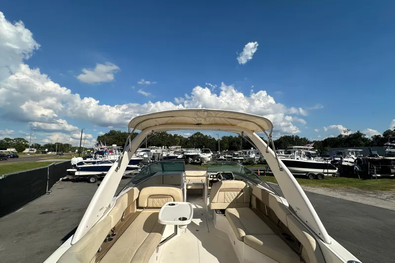 Slide: The Image of 2019 Regal 26 OBX boat with spacious seating, parked under a clear blue sky. - 17