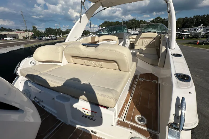 Slide: The Image of 2019 Regal 26 OBX boat interior with beige seating and open deck under blue sky. - 22