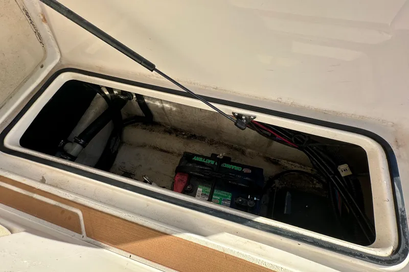 Slide: The Image of 2019 Regal 26 OBX boat battery compartment with visible wiring and components. - 24