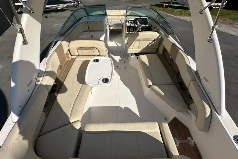Slide: The Image of 2019 Regal 26 OBX boat interior with beige seating and a central table. - 27