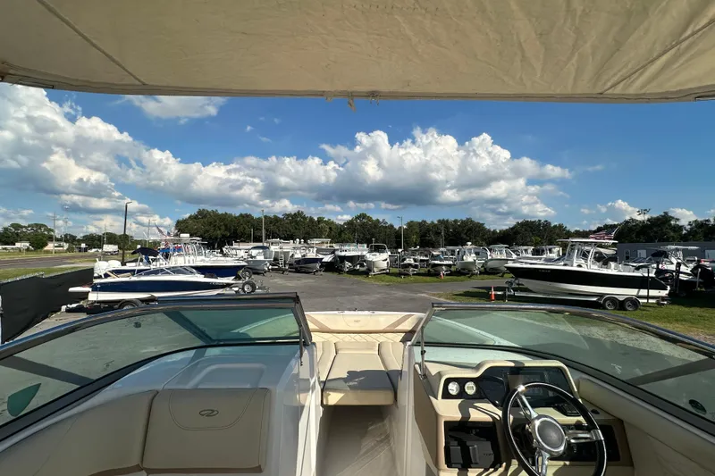 Slide: The Image of 2019 Regal 26 OBX boat interior with marina view under blue sky. - 28