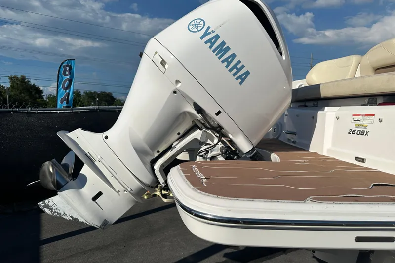 Slide: The Image of 2019 Regal 26 OBX boat with Yamaha outboard motor, docked under a clear sky. - 3