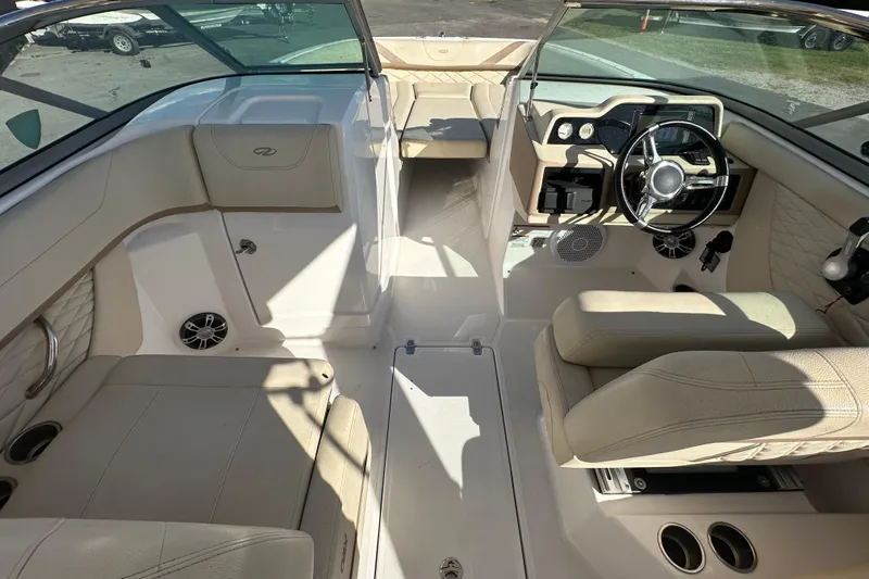 Slide: The Image of 2019 Regal 26 OBX boat interior with beige seating and modern dashboard. - 30