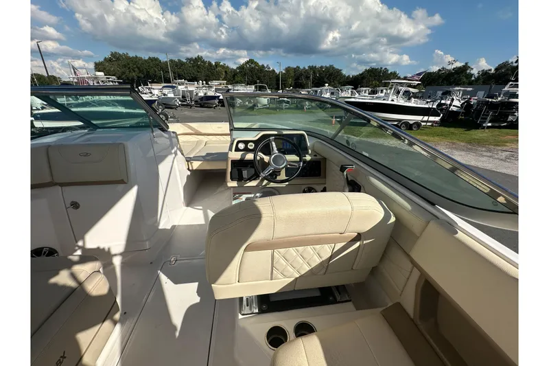 Slide: The Image of Interior view of 2019 Regal 26 OBX boat with beige seating and steering console. - 33
