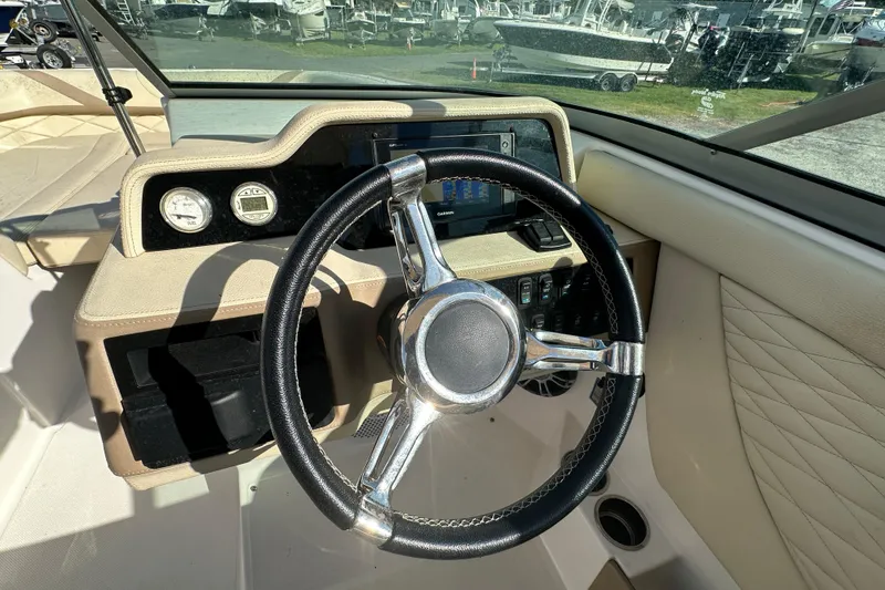Slide: The Image of 2019 Regal 26 OBX boat dashboard with steering wheel and gauges. - 35