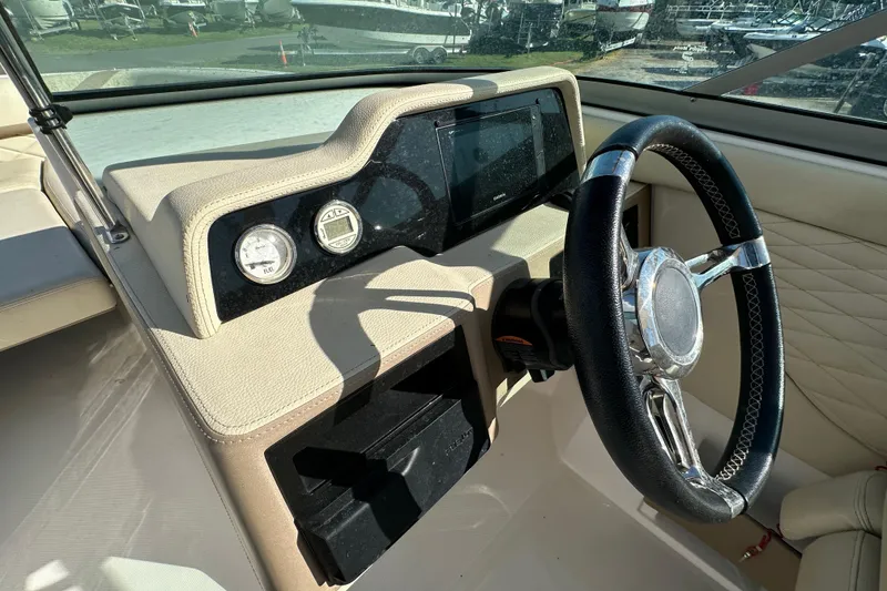 Slide: The Image of 2019 Regal 26 OBX boat dashboard with steering wheel and gauges. - 36